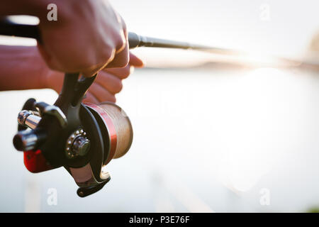 Fishing, hobby and recreational concept - fishermen Stock Photo