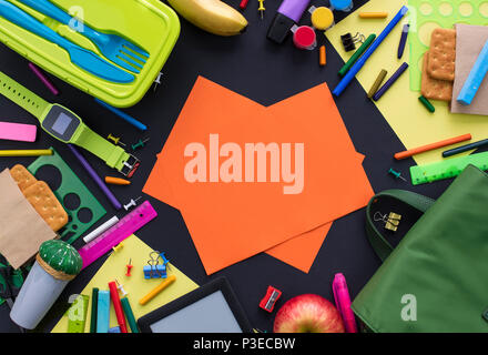 Concept back to school apple backpack stationery on black background. Top view Flat lay Stock Photo