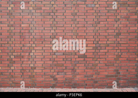 Brick wall made of many red bricks as a background texture Stock Photo