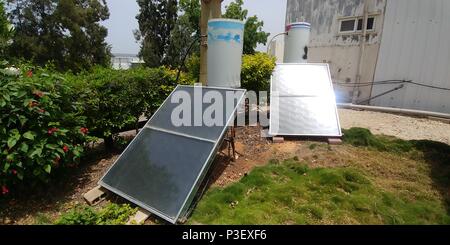 Close up Solar water heater collectors on lawn. Photographed in Israel Stock Photo