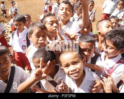 Excited schoolchildren in uniform, on a school trip, viewing ...