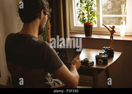 Man using digital tablet in living room Stock Photo