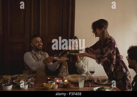 Friends having meal at table Stock Photo