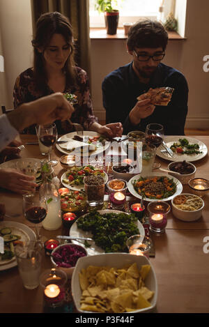 Friends having meal at table Stock Photo