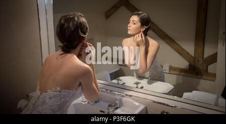 Bride getting ready in front of the mirror Stock Photo