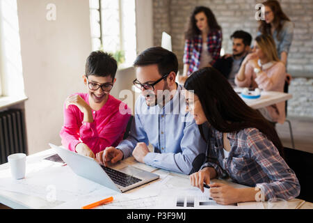 Group of young architects working on computer Stock Photo