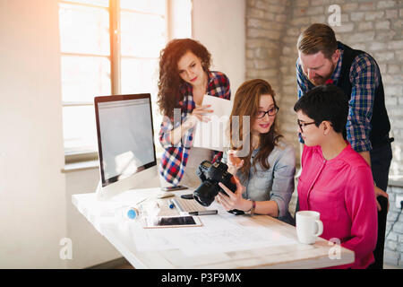 Group of young perspective designers working with camera Stock Photo