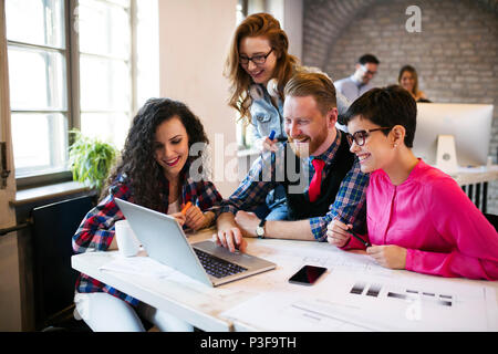 Group of young architects working on laptop Stock Photo