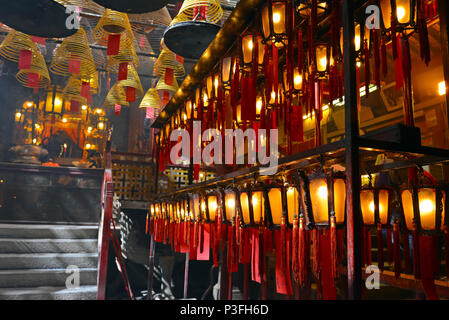 Incense burning with lanterns in dimly lit, traditional Temple in Hong Kong, China Stock Photo