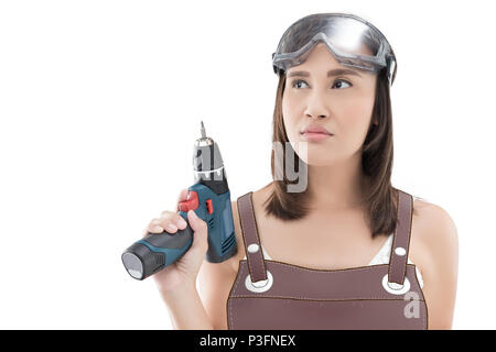 Asian woman with cordless drill ready for home repairs. People holding electric tool. isolated on white background. Stock Photo