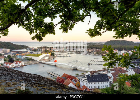 Mandal, Norway - june 2018: Mandal, a small town in the south of Norway. Seen from a height, with a cliff and an oak tree in the foreground. Stock Photo