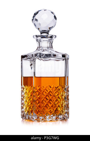 A half full crystal whisky decanter, with amber alcohol, shot on white, with a small reflection Stock Photo