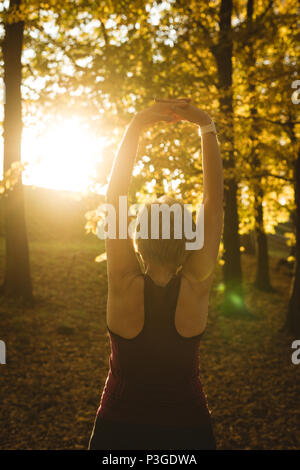 Senior woman practicing exercise in the park Stock Photo