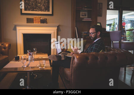Businessman using laptop and mobile phone Stock Photo