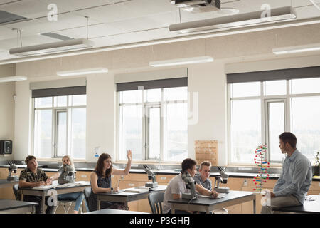 Teacher assisting students in experiment on molecule Stock Photo