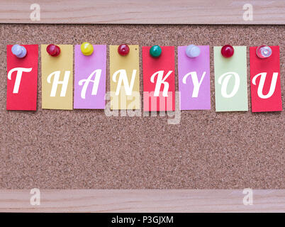 Colored Sticky Notes with White Words Thank You Pinned  to a Cork Message Board Stock Photo