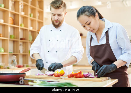 Two Chefs Working in Kitchen Stock Photo