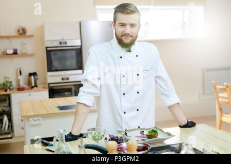 Handsome Chef Posing in Kitchen Stock Photo