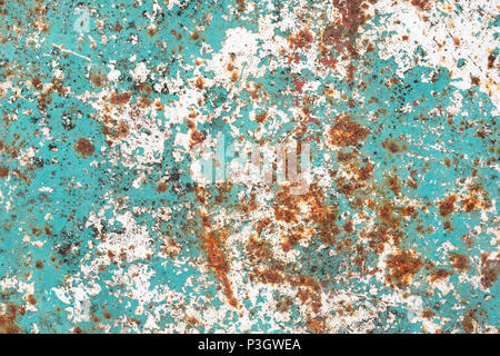 Grunge texture of old cracked paint with cracks and rust spots. Turquoise rough rustic background. Textured wall. Stock Photo