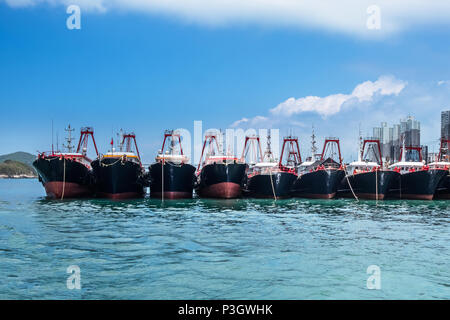 Fishing trawlers anchored in Aberdeen Bay, Hong Kong. Modern nautical vessels in fish industry. Stock Photo