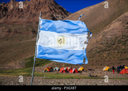 Argentinian flag waving in front of campsite on approach hike to Aconcagua in Mendoza, Argentina Stock Photo