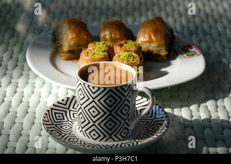 01.06.2018, Selcuk, Turkey: Baklava pieces and turkish coffee are on a table. The traditional pastry is a pastry made of leafy or filo pastry stuffed with sugar syrup filled with chopped walnuts, almonds or pistachios. Photo: Jens Kalaene/dpa central image/dpa | usage worldwide Stock Photo