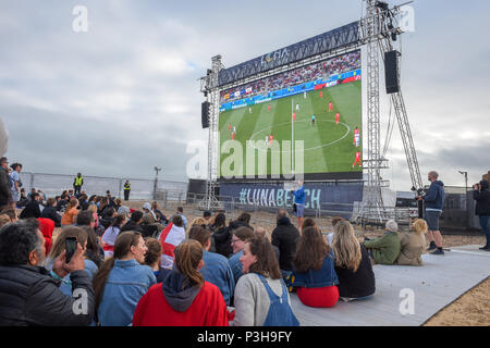Brighton UK 18th June 2018 - Thousands of England football fans watch the match on a giant screen put up by Luna on Brighton seafront as they play against Tunisia in the World Cup being held in Russia Stock Photo