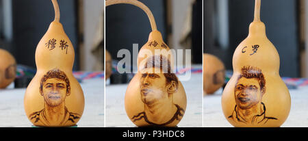 Zouchen, Zouchen, China. 18th June, 2018. Zoucheng, CHINA-18th June 2018: The folk artist Liu Yongjun makes gourd pyrography handicrafts in Zoucheng, east China's Shandong Province, marking the ongoing World Cup 2018. The portraits of famous football stars including Lionel Messi, Neymar da Silva Santos JÃƒÂºnior and Cristiano Ronaldo can be seen on the gourds. Credit: SIPA Asia/ZUMA Wire/Alamy Live News Stock Photo