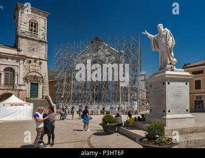 San Benedetto Monument, and facade, supported by scaffolding, of Basilica, destroyed by earthquakes, April 2018 view, in Norcia, Umbria, Italy Stock Photo