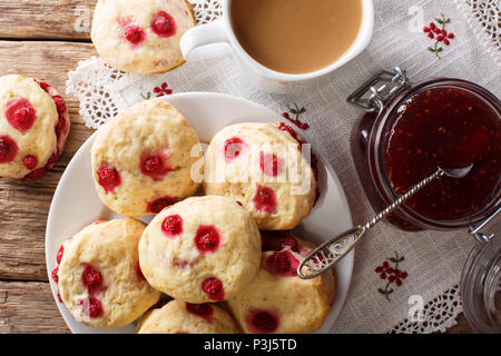 English sconces biscuits with red currants are served with tea and milk close-up on the table. horizontal top view from above Stock Photo