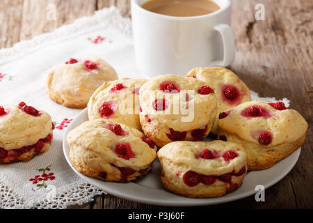 English sconces biscuits with red currants are served with tea and milk close-up on the table. horizontal Stock Photo