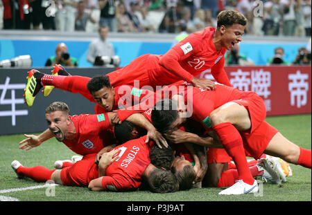 England's Harry Kane (hidden) is mobbed by team-mates as he scores his side's first goal of the game during the FIFA World Cup Group G match at The Volgograd Arena, Volgograd. Stock Photo