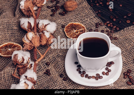 Black coffee on the table with burlap cotton and roasted coffee beans Stock Photo