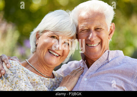Happy senior couple embracing in garden, head and shoulders Stock Photo