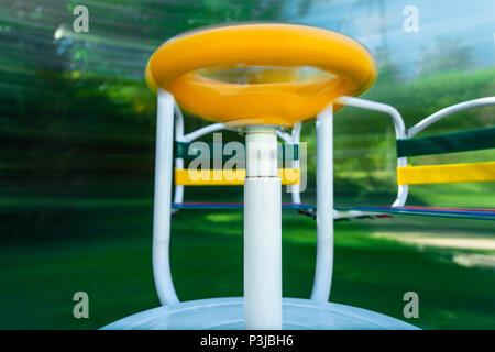 Picture of a merry-go-round (playground equipment) taken in movement. Long exposure to show how it spins and motion. Stock Photo