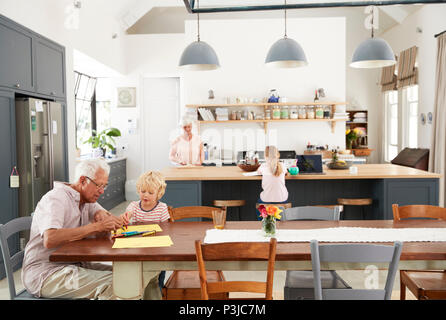 Grandparents and grandkids spending time in family kitchen Stock Photo