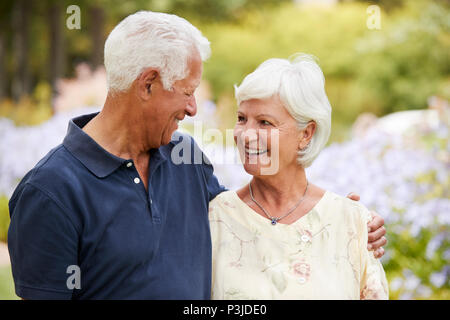 Senior Couple Enjoying Walk In Park Together Stock Photo