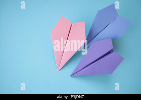 Flat lay of three paper planes on pastel blue background with text space. Stock Photo