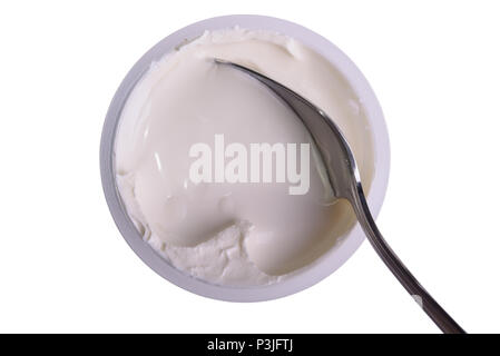Fresh sour cream in a container with a spoon, isolated on white, top view Stock Photo