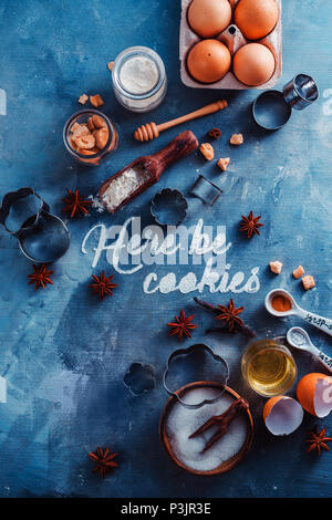 Pastry recipe concept from above with baking tools and ingredients. Food typography with Here be Cookies text on a marble table Stock Photo