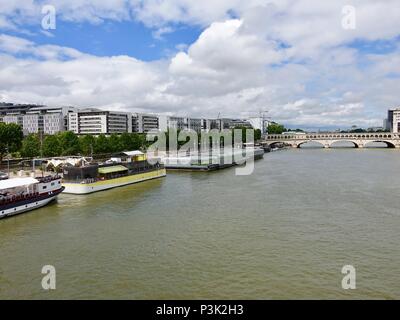 Left bank in 13th arrondissement with Josephine Baker pool, and metro line 6 crossing Point de Bercy, Paris, France Stock Photo