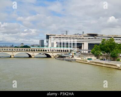 Line 6 train crossing the Pont de Bercy above the River Seine from the right bank, seen from a distance, Paris, France Stock Photo