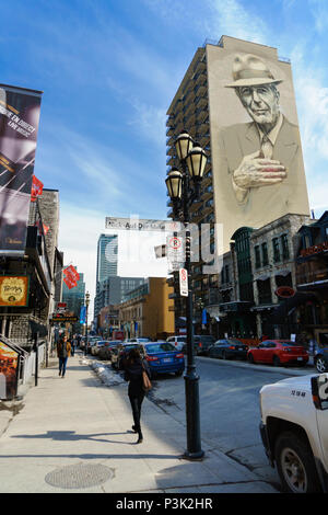 Pedestrians on Crescent street, at the corner of Nick-Auf Der Maur, Montreal. A giant mural of Leonard Cohen is visible on the building on the right. Stock Photo