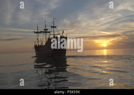 CLEARWATER BAY, CLEARWATER, FLORIDA-FEBRUARY 7, 2018: Silhoutted pirate ship, a historic replica, ferries tourists around scenic Clearwater Bay at sun Stock Photo