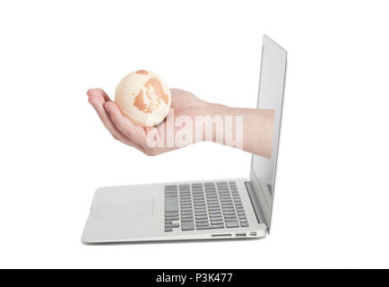 Hand holding earth globe coming from screen laptop isolated on white background Stock Photo