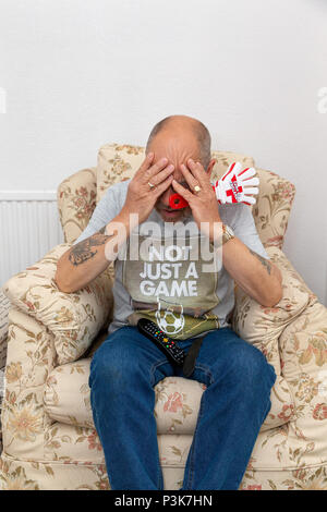 18 June 2018 - Man at home watching and supporting England playing football in the 2018 World Cup showing a lot of emotion throughout the match Stock Photo