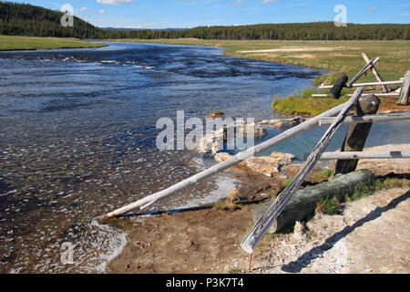 Maidens Grave Hot Spring flowing into the Firehole River in Yellowstone National Park in Wyoming United States Stock Photo