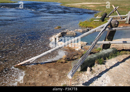 Maidens Grave Hot Spring flowing into the Firehole River in Yellowstone National Park in Wyoming United States Stock Photo