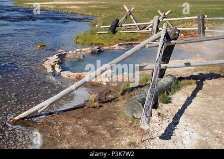 Maidens Grave Hot Spring flowing into the Firehole River in Yellowstone National Park in Wyoming United States Stock Photo