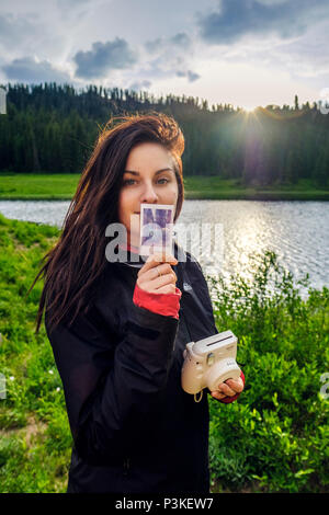 Woman with instant camera on Colorado Trail, Colorado, USA Stock Photo